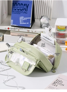 Detailed interior of a green high-capacity pencil case showing multiple mesh pockets