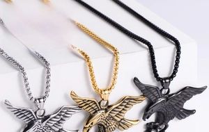 Detailed view of punk eagle pendants in gold, silver, and black metal finishes