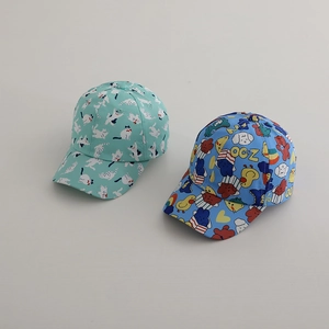 Flat lay of cute mint and blue cartoon print baseball caps for children outdoors