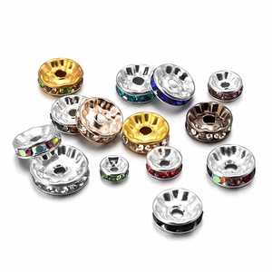 Close-up of colorful rhinestone spacer beads in gold and silver finish for DIY jewelry