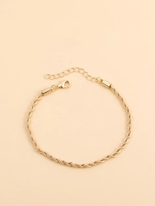 Detailed close-up of a twisted rope chain bracelet in gold with an adjustable lobster clasp