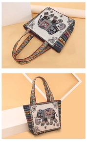 Detail of ethnic canvas tote bag featuring elephant patterns and colorful woven straps