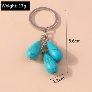 Detail shot of turquoise water drop key ring showing 8.6cm length and 17g weight specs
