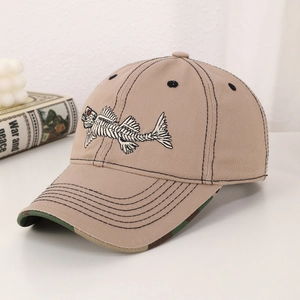 Khaki embroidered fishbone baseball cap with camo brim on a white desk backdrop