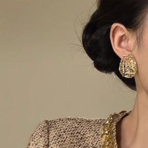 Gold plated oval zircon stud earrings with intricate openwork mesh for a vintage luxury look