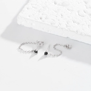 Detail of S925 sterling silver chain stud earrings with a black round gemstone