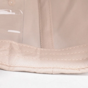Detailed macro view of beige cotton twill stitching and transparent PVC insert window