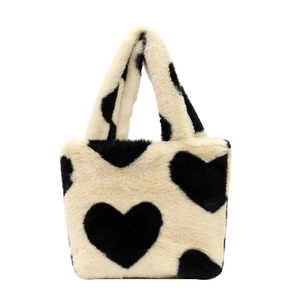 Plush heart pattern tote bag in soft black and white faux fur with sturdy handles