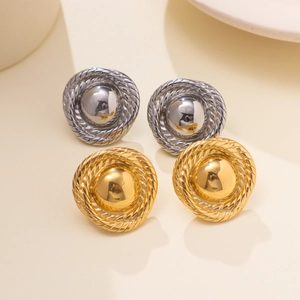 Detail of gold and silver round stud earrings with textured rope border and polished finish
