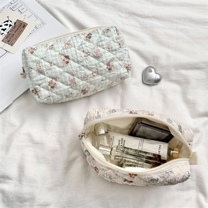 Detailed close-up of quilted cotton cosmetic bags with cute rabbit and bear patterns