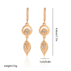 Detail view of leaf-shaped champagne gold earrings with white zircon and dimensions