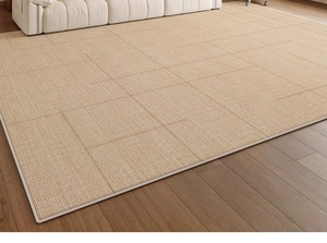 Detail view of woven wheat color sisal rug with white reinforced border on wood floor