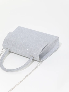 Detailed close-up of a silver glitter evening bag with sequins and metal chain strap