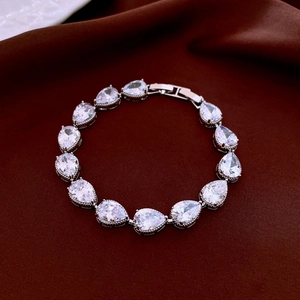 Detailed view of pear-cut zircon stones and silver clasp on luxury tennis bracelet