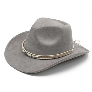 Detail of grey suede cowboy hat featuring woven band and evil eye bead decorations