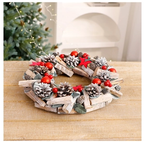 Macro shot of rustic Christmas wreath with wood pieces, pine cones and red berries