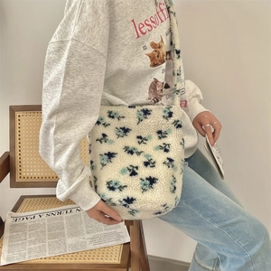 Detail view of plush leopard print bucket bag with soft wide shoulder strap for women