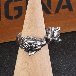 Macro shot of double wolf head vintage ring with blackened detail on a wooden stand