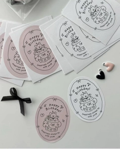 Detail of pink and white oval Happy Birthday stickers with cute bear cake illustrations