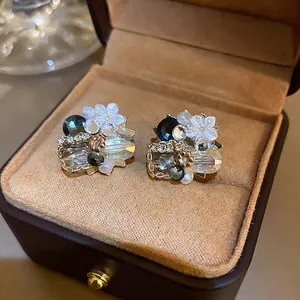 Vintage floral drop earrings featuring pearls and green crystals on a gold base