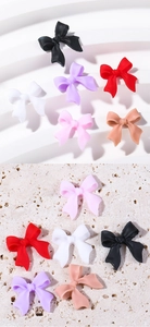 Macro shot of 3D matte resin bow nail charms in various colors for DIY manicure designs