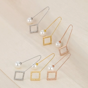 Detailed view of geometric drop earrings with pearls and crystal square charms in three colors