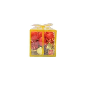 Christmas tree decoration set with red balls, gold bells and drums in a clear gift box