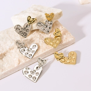 Hammered texture double heart drop earrings in gold, silver and white tones on stone base