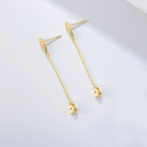 Detail of S925 sterling silver gold-plated long chain tassel earrings on white background