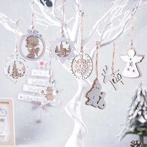 Assorted wooden Christmas ornaments with reindeer and star shapes on white branches