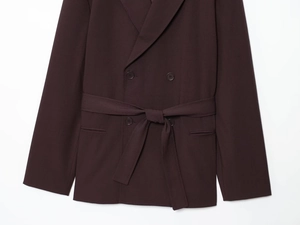Detail of dark coffee double-breasted blazer with waist belt and textured fabric