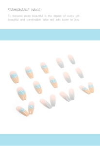 Detail of long coffin nails with blue gradient finish and delicate heart patterns