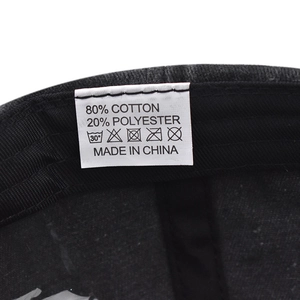 Detail view of cotton baseball cap washing label showing material and care instructions