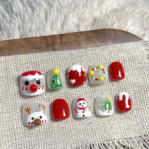 Handmade Christmas press-on nails for kids with hand-painted reindeer and snowman motifs