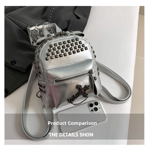 Detail view of silver mini punk backpack with square rivets and metal cross charm