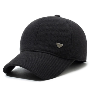 Warm black knitted baseball cap with ribbed texture and metal triangular badge detail
