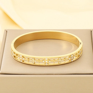 Detail of 18K gold plated stainless steel hollow bangle with sparkling pavé crystals
