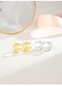 Close-up of S925 sterling silver hoop earrings in gold and silver finish with wide band