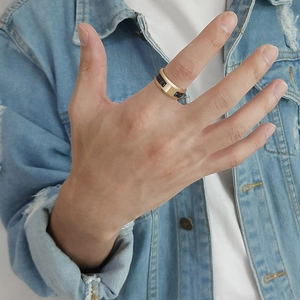 Close-up of 8mm men's gold stainless steel ring with deep blue gemstone inlay on hand