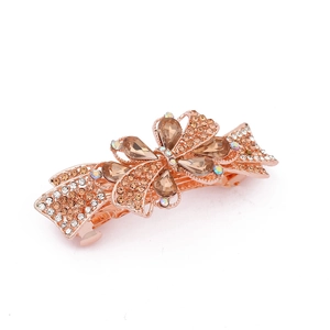 Detailed macro view of rose gold spring hair clip with sparkling rhinestone butterfly design