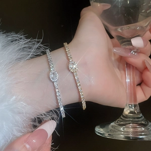 Detailed view of elegant gold and silver oval zircon bracelets with sparkling pavé crystals