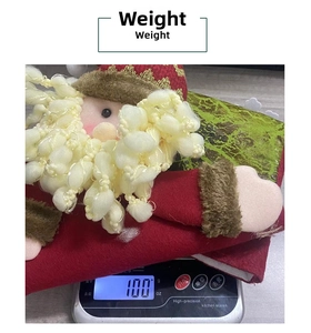 Detail showing weight measurement of a plush 3D Santa Christmas stocking at 100 grams