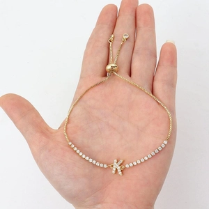 Gold tennis bracelet with zirconia letter K charm and adjustable pull-cord chain