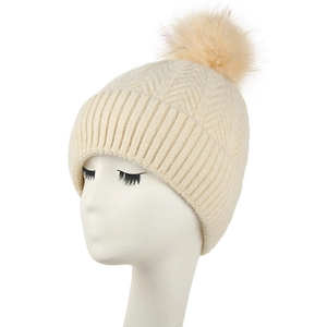 Women's cream knit beanie with faux fur pom pom and warm fleece lining for winter outdoors