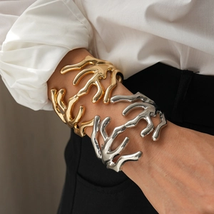 Irregular lava style open bangle bracelets in gold and silver with high-gloss mirror finish