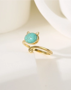 Detail of a gold cat-shaped ring setting featuring turquoise stone and cute cat ears