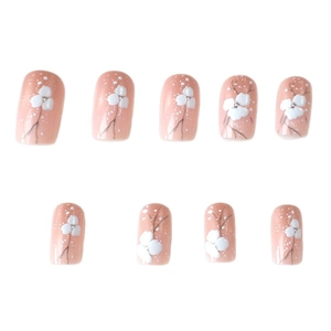 Faux ongles roses à coller avec fleurs blanches peintes à la main et tiges noires