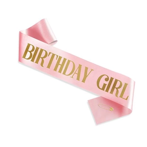 Pink satin Birthday Girl sash with glitter gold lettering and a gold safety pin detail