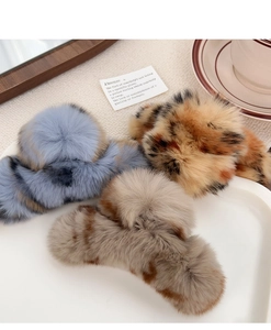 Detailed view of large plush rabbit fur claw clips with spot patterns in multiple colors