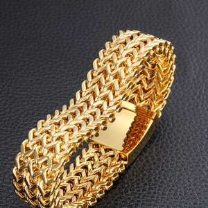 Men's fashion square fish scale gold stainless steel bracelet on black leather background